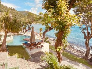 a resort with a pool and a beach at Amed Santorini Villa in Amed