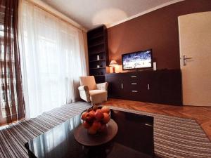 a living room with a bowl of fruit on a table at Apartment Alex 2 in Belgrade