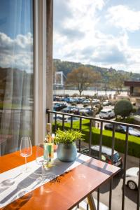 a table with wine glasses and a view of a parking lot at Danube Apartment in Budapest