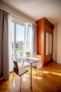 a dining room with a table and a large window at Danube Apartment in Budapest