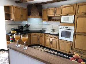 two glasses of wine sitting on a counter in a kitchen at La maison poitevine in Chauvigny +11 photos