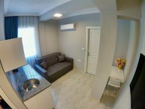 a living room with a couch and a table at MirAlya Homes in Fethiye