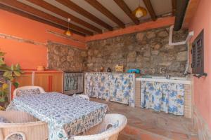 a kitchen with a table and chairs in a room at Villetta Fiorita - HelloElba in Rio Marina