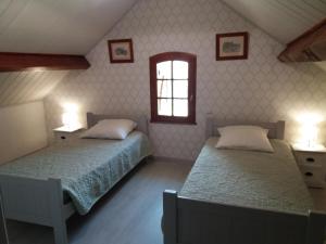 a bedroom with two beds and a window at Clé des champs in Antran