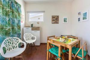a kitchen and dining room with a table and chairs at Formosa Beach in Porto Santo