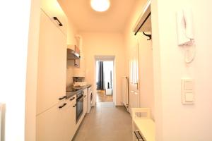 a hallway of a kitchen with a long hallway at UNIVERSUM APARTMENT 4 in Vienna