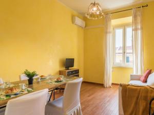 a dining room with a table and white chairs at The Best Rent - Colourful two-bedroom apartment near Termini Station in Rome