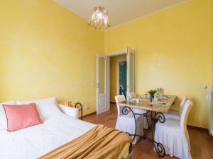 a bedroom with a bed and a table and chairs at The Best Rent - Colourful two-bedroom apartment near Termini Station in Rome