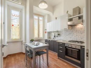 a kitchen with a table and a stove top oven at The Best Rent - Colourful two-bedroom apartment near Termini Station in Rome