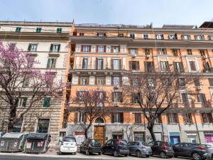 a large building with cars parked in front of it at The Best Rent - Colourful two-bedroom apartment near Termini Station in Rome