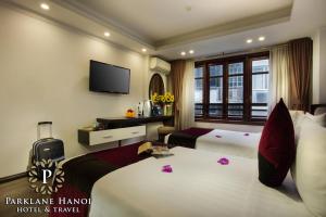 a hotel room with a bed and a television at Parklane Central Hanoi Hotel in Hanoi