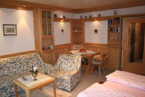 a living room with a couch and a table at Panorama Appartement Predigtstuhl in Bad Reichenhall