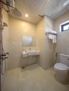 La salle de bains est pourvue de toilettes et d'un lavabo. dans l'établissement Khách sạn Phạm Gia Đà Nẵng (Phạm Gia Hotel), à Đà Nẵng
