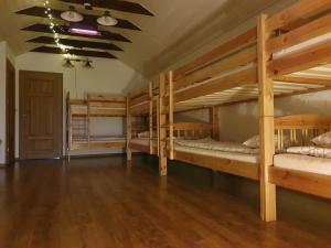 a large room with four bunk beds in it at Sodyba PILIAKIEMIS in Kurkliškės