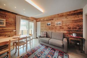 a living room with a couch and a table at Appartamenti Residence Lares Ossana in Fucine