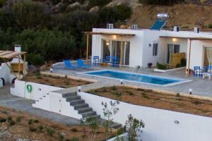 a house with a swimming pool in front of it at Sea view Villa in Koutsounari