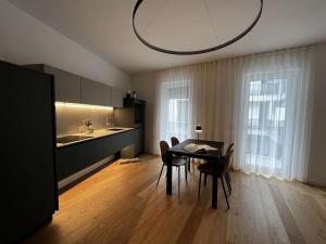 a kitchen and dining room with a table and chairs at Al civico 50 in Andria