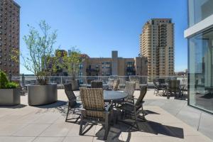 a patio with a table and chairs on a roof at South Loop studio w pool gym nr Grant Park CHI-856 in Chicago