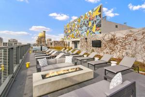 a rooftop patio with couches and a fire pit at Streeterville 2br w pool gym nr Riverwalk CHI-881 in Chicago