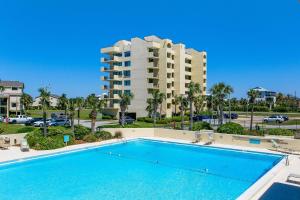 una piscina frente a un gran edificio de apartamentos en Santa Rosa Dunes 923 en Pensacola Beach