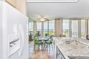 a kitchen and dining room with a table and chairs at Santa Rosa Dunes 923 in Pensacola Beach