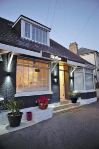 a store front of a house with plants in front at Skyline Guesthouse Newquay in Newquay