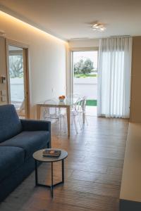 a living room with a couch and a table at Sea Breeze in Caorle