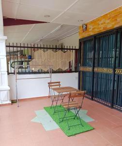 a picnic table and two chairs on a patio at The Loft Bentong in Bentong