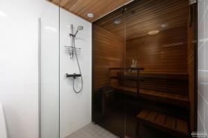 a bathroom with a shower and a glass shower stall at Hilmantori Apartments by Hiekka Booking in Kalajoki