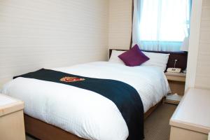 Postel nebo postele na pokoji v ubytování Grand Park Hotel Excel Kisarazu