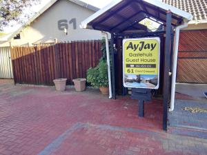 a sign for aeway costs a guest house in front of a building at Ay Jay's Guesthouse in Bloemfontein