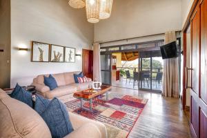 a living room with a couch and a table at Ilala Lodge Hotel in Victoria Falls