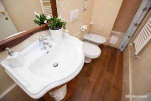 a bathroom with a white sink and a toilet at La Serra Sul Mare in Monterosso al Mare