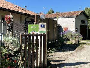 a gate in front of a house with a sign at Le balét in Asnois