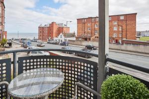 a bench on a balcony with a view of a street at Host & Stay - Beach Pad in Whitby