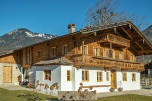 a large house with a wooden roof at Geigelstein Chalets in Unterwössen