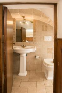 a bathroom with a sink and a toilet at La Casa dell'oste in Monopoli +17 photos