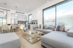 a living room with two couches and a table at Luxury 3BR on Frishman SEA u TLV in Tel Aviv
