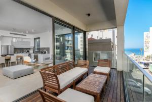 an apartment balcony with a view of the ocean at Luxury 3BR on Frishman SEA u TLV in Tel Aviv