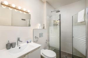 a bathroom with a toilet and a sink and a shower at Luxury 3BR on Frishman SEA u TLV in Tel Aviv +9 photos