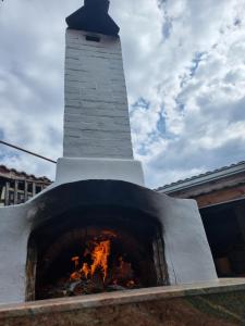 a brick oven with a lighthouse in the background at villa Tia Maria in Hisarya