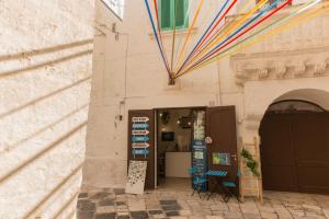 a store with colorful kites hanging from a building at La Casa dell'oste in Monopoli