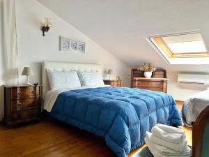a bedroom with a bed with a blue blanket at Villa Roma Holidays in Jesolo +67 photos
