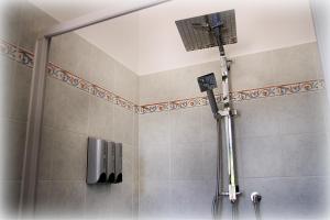 a shower with a shower head in a bathroom at Tenuta Piana 2 con accesso diretto al mare in Caronia