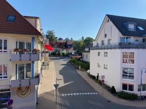 an empty street in a town with white buildings at Schwarzwaldblick in Sankt Georgen im Schwarzwald