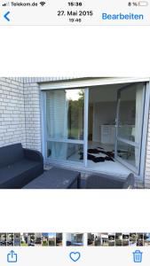 a picture of a window with a couch and chairs at Moderne Ferienwohnung in Strandnähe in Surendorf