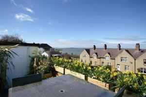 a view from the roof of a house with flowers at Sunset View in Llanfairfechan