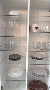 a glass shelf with plates and dishes on it at El Mirador del Valle, a 9 min de Comillas in Comillas