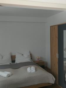 a bedroom with a bed with two towels on it at TEREC HAUS in Bruckneudorf