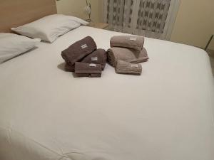 two brown towels sitting on top of a bed at stella marina in Laigueglia